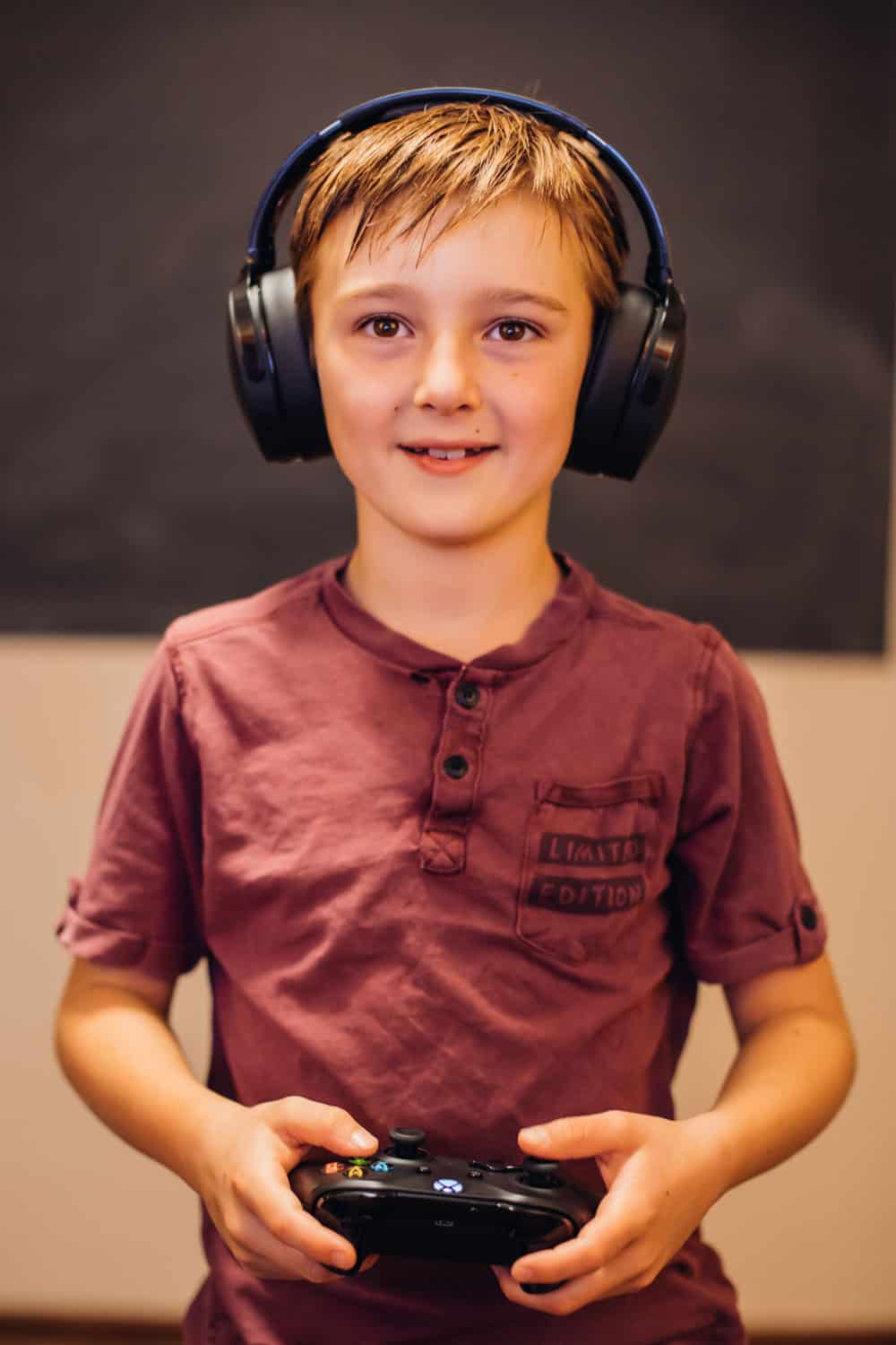 A boy playing video game and headphones in clinic