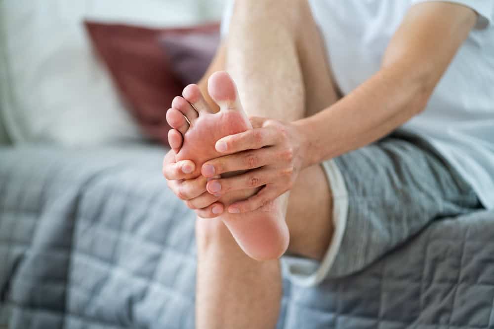 Foot Pain Man Suffering From Feet Ache In Home Interior