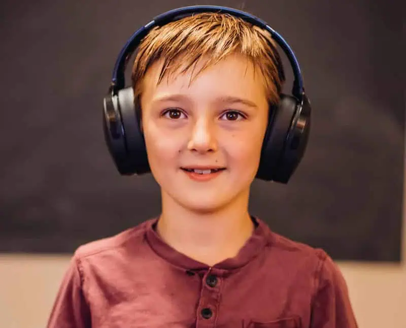 A boy playing video game and headphones in clinic